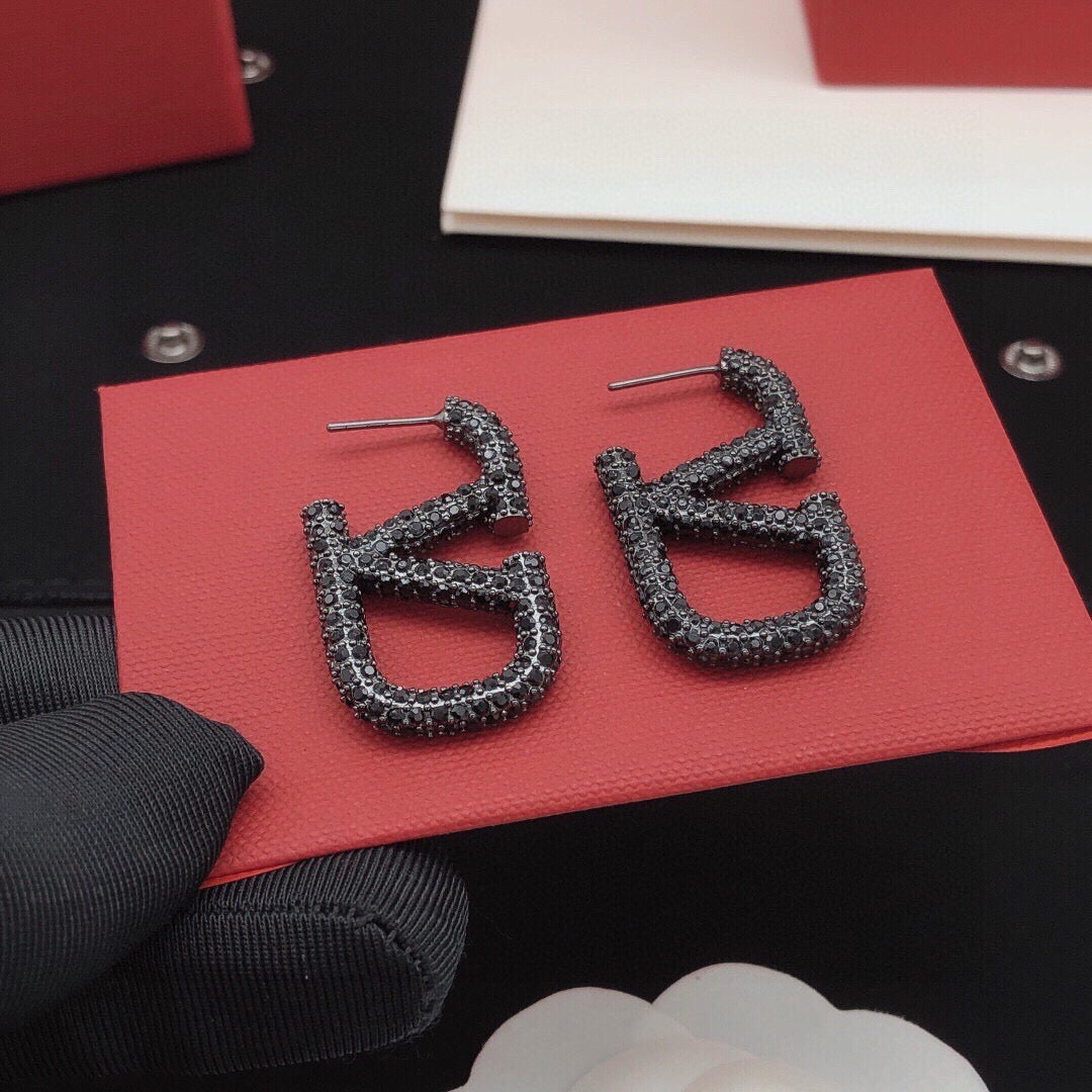Martin Graham stud earrings in polished metal-tone – detail view
