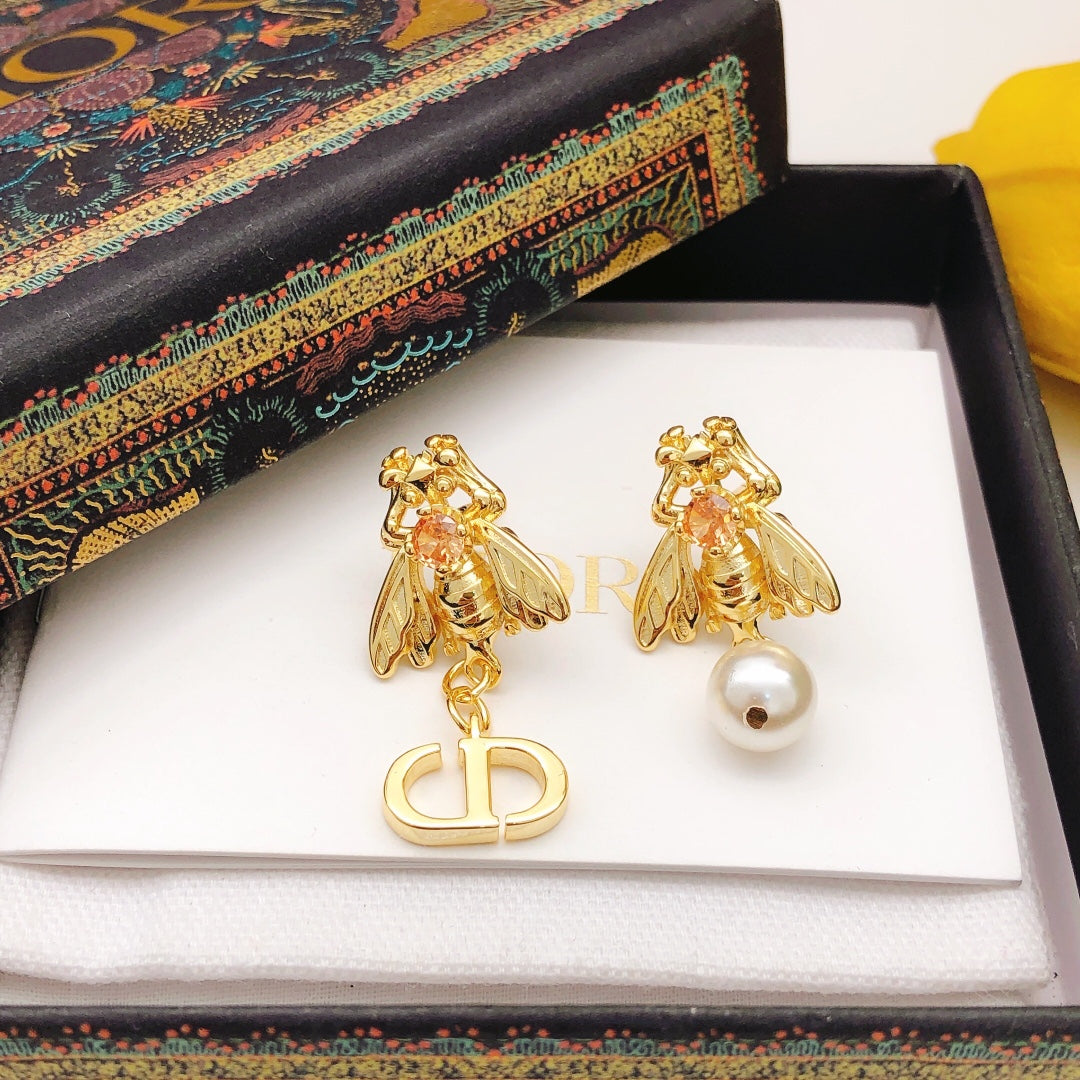 Martin Graham stud earrings in polished metal-tone – detail view