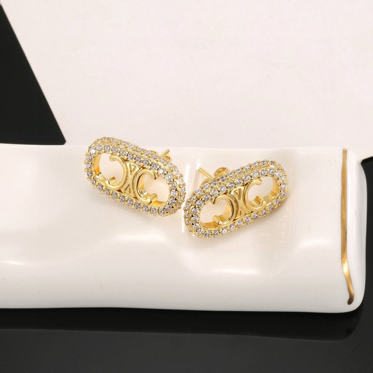 Martin Graham stud earrings in polished metal-tone – detail view