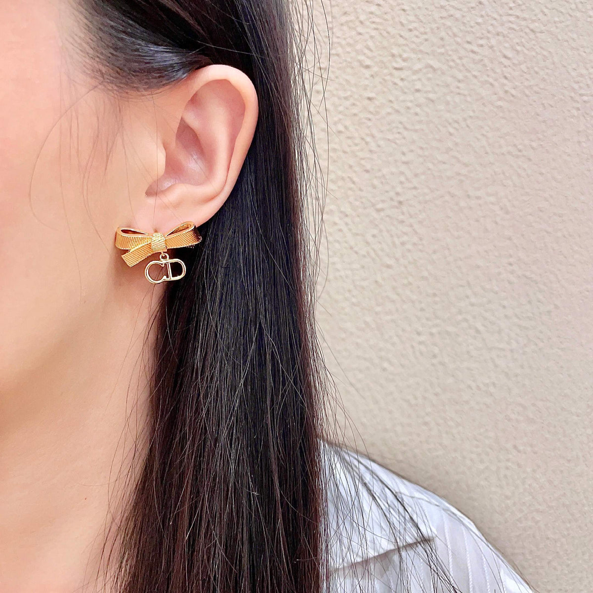 Martin Graham stud earrings in polished metal-tone – detail view