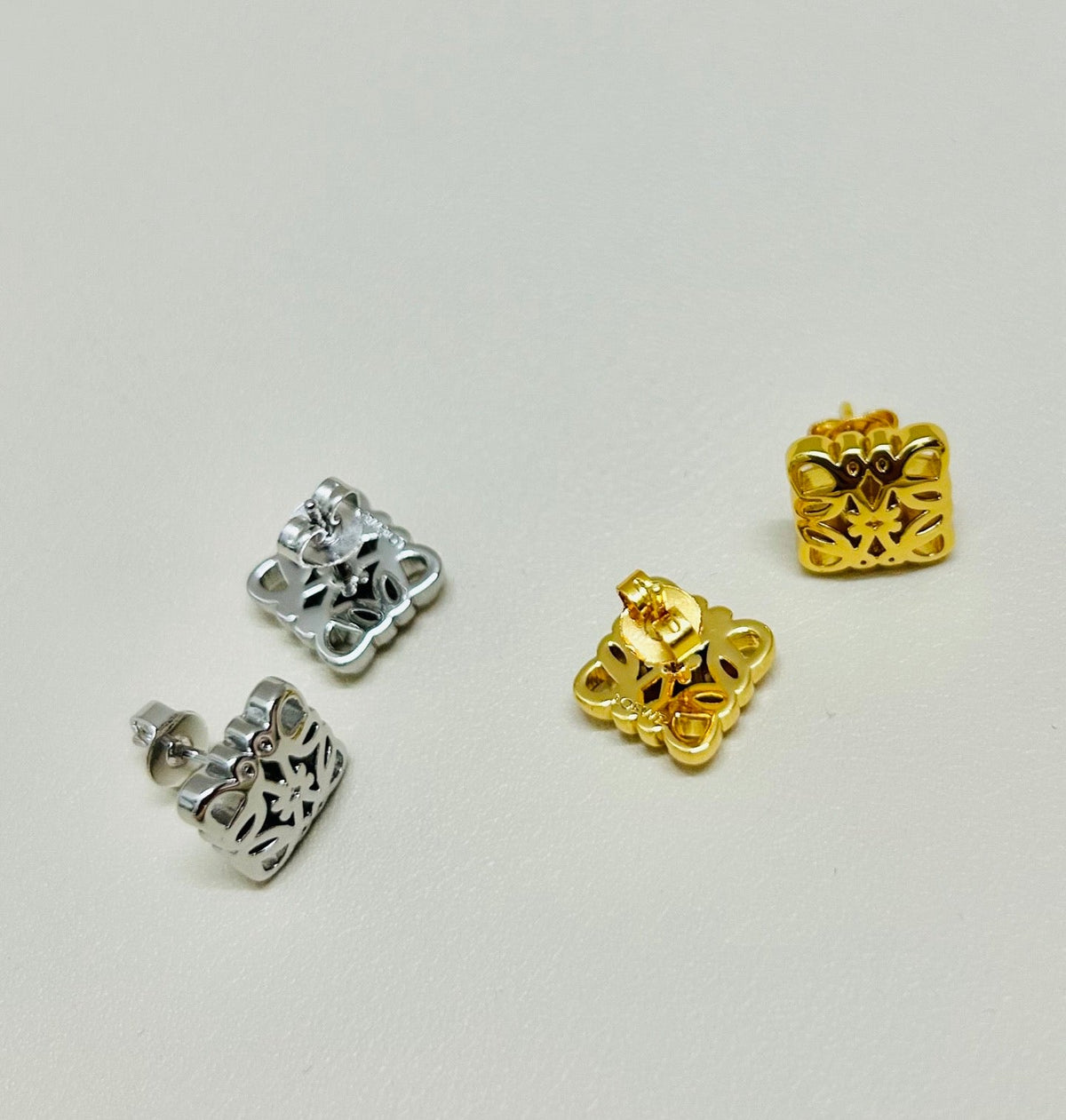 Martin Graham stud earrings in polished metal-tone – detail view