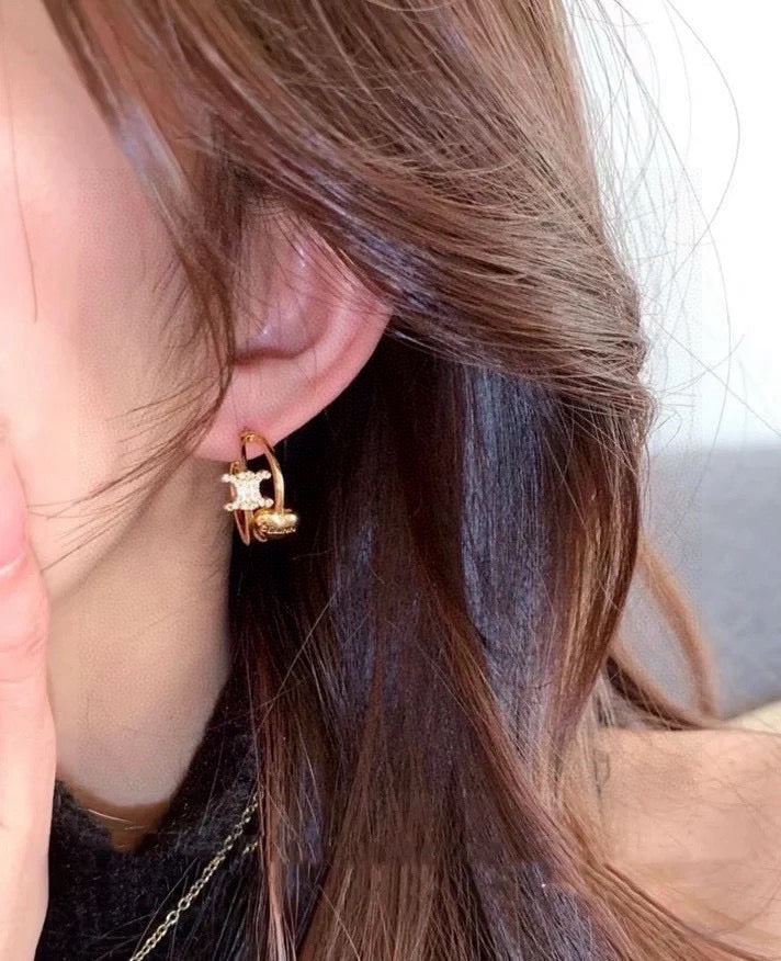 Martin Graham stud earrings in polished metal-tone – detail view