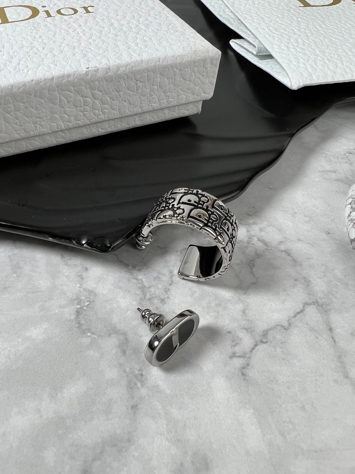 Martin Graham stud earrings in polished metal-tone – detail view