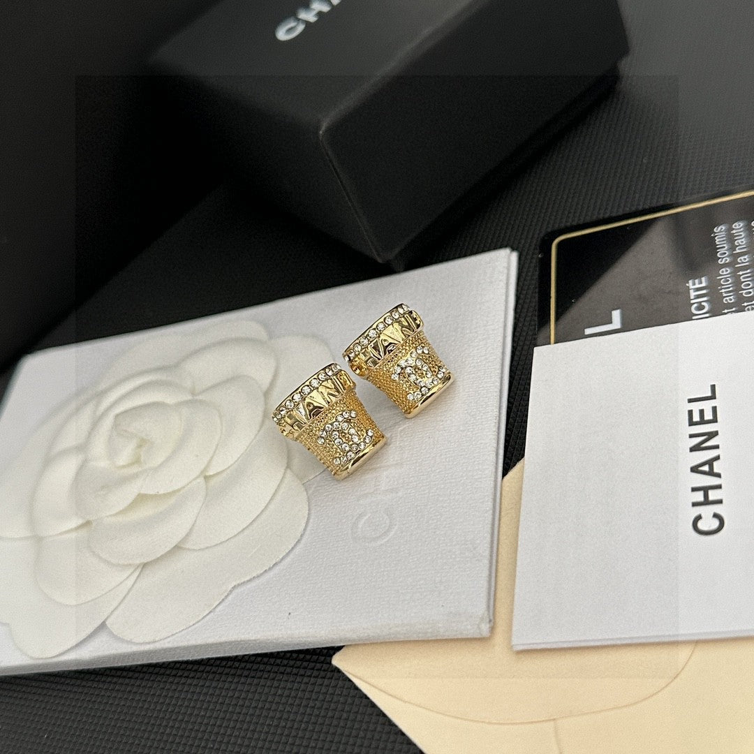 Martin Graham stud earrings in polished metal-tone – detail view