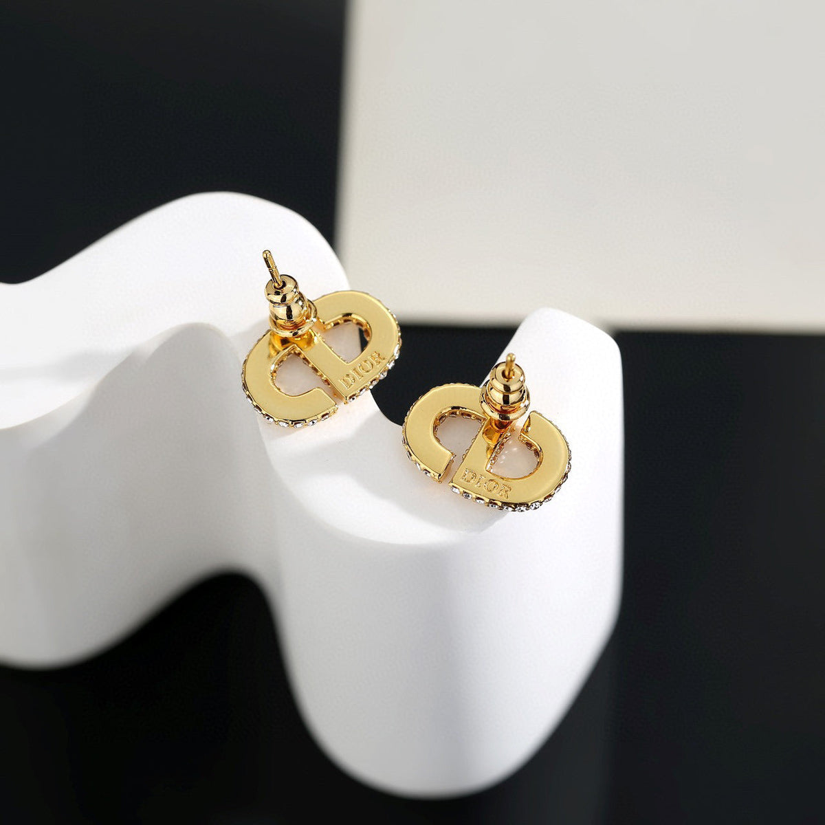 Martin Graham stud earrings in polished metal-tone – detail view