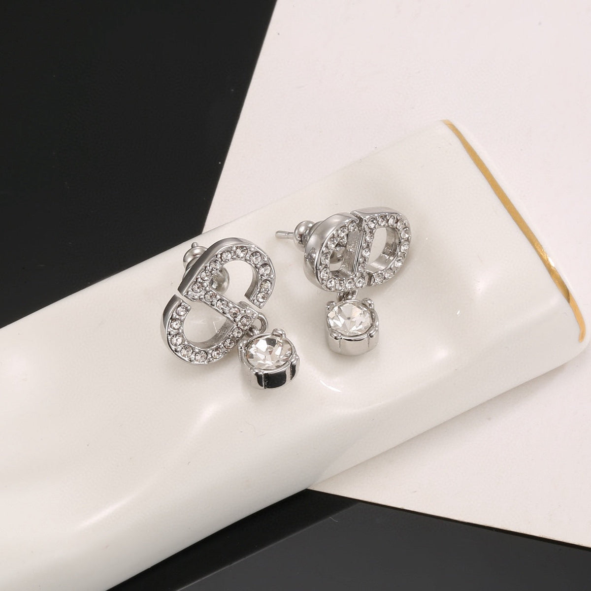 Martin Graham stud earrings in polished metal-tone – detail view