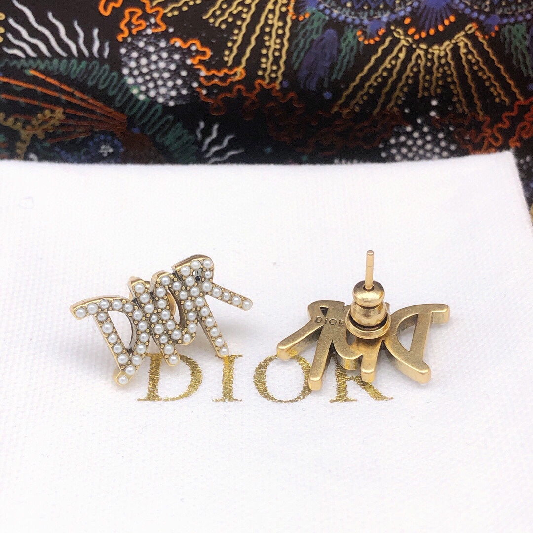 Martin Graham stud earrings in polished metal-tone – detail view
