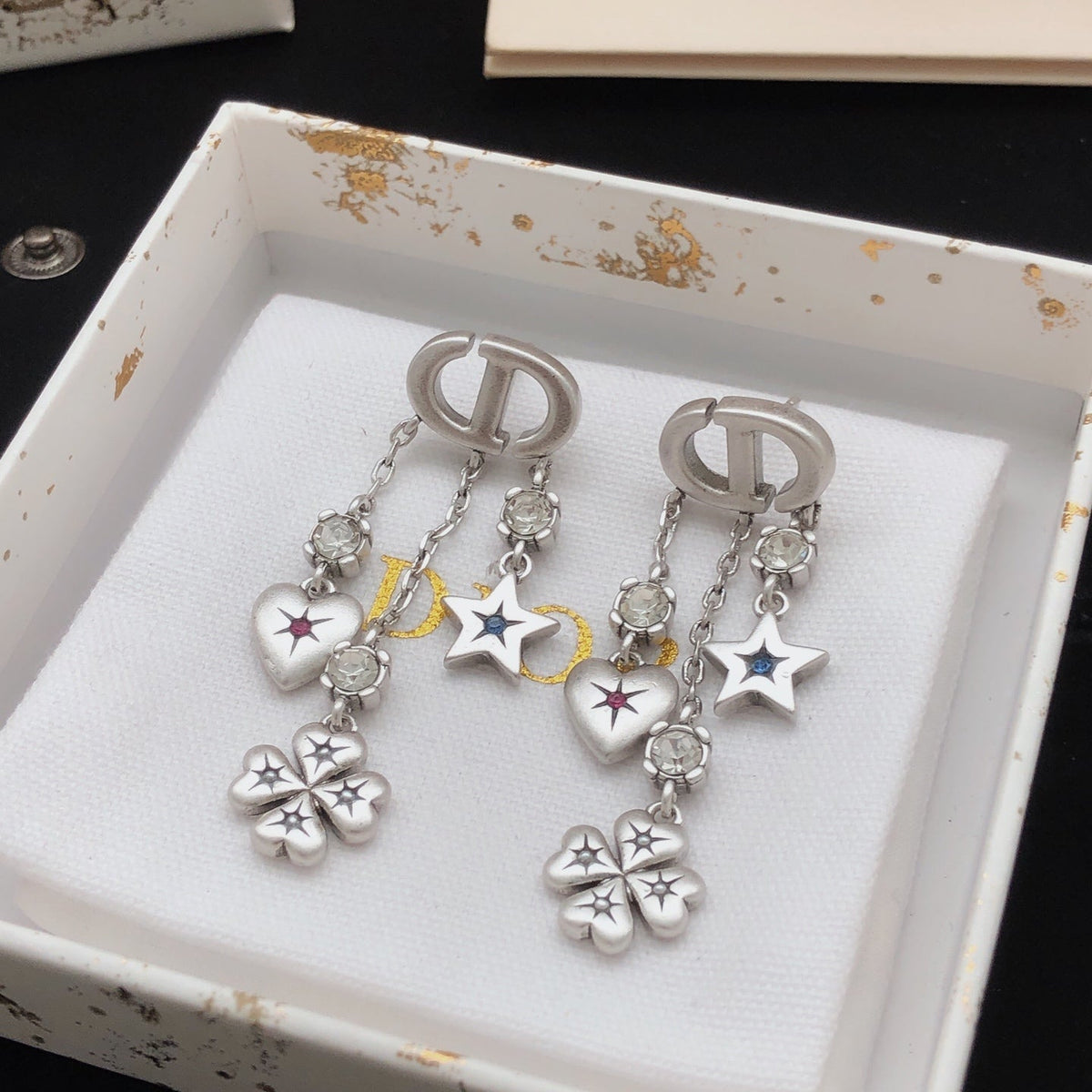 Martin Graham stud earrings in polished metal-tone – detail view