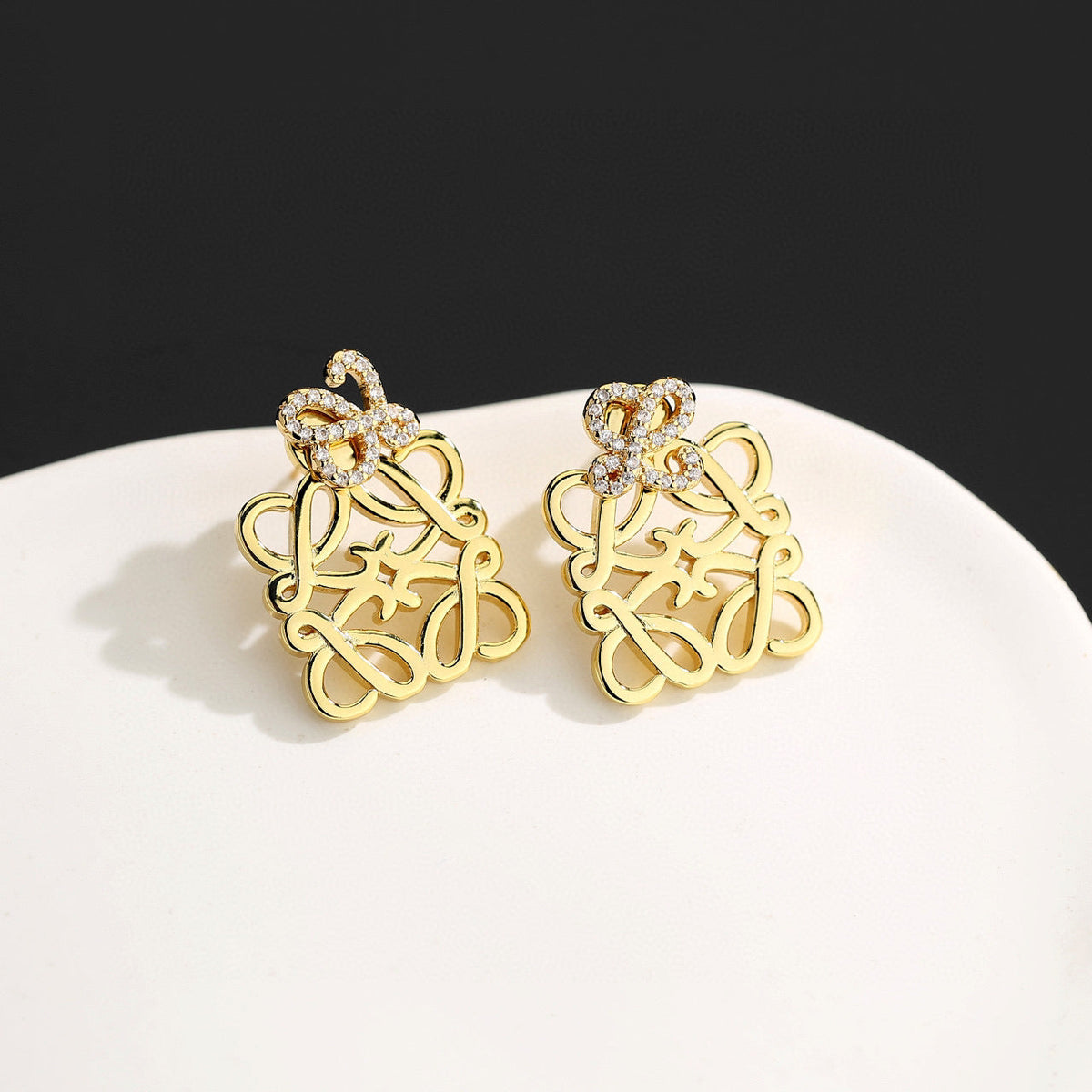 Martin Graham stud earrings in polished metal-tone – detail view