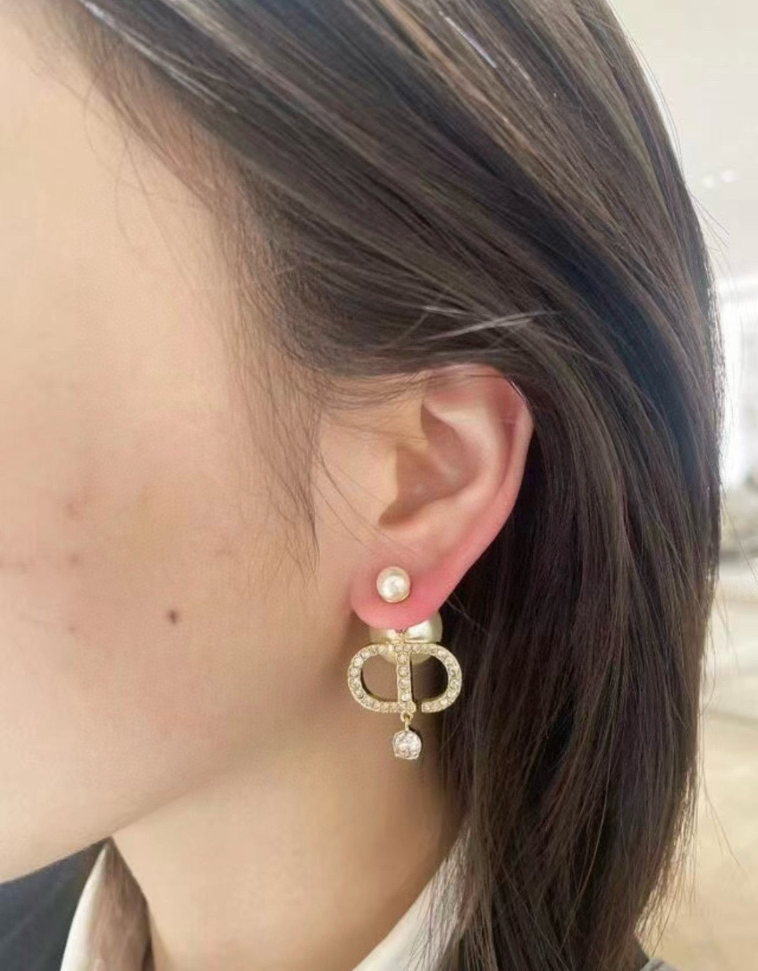 Martin Graham stud earrings in polished metal-tone – side detail