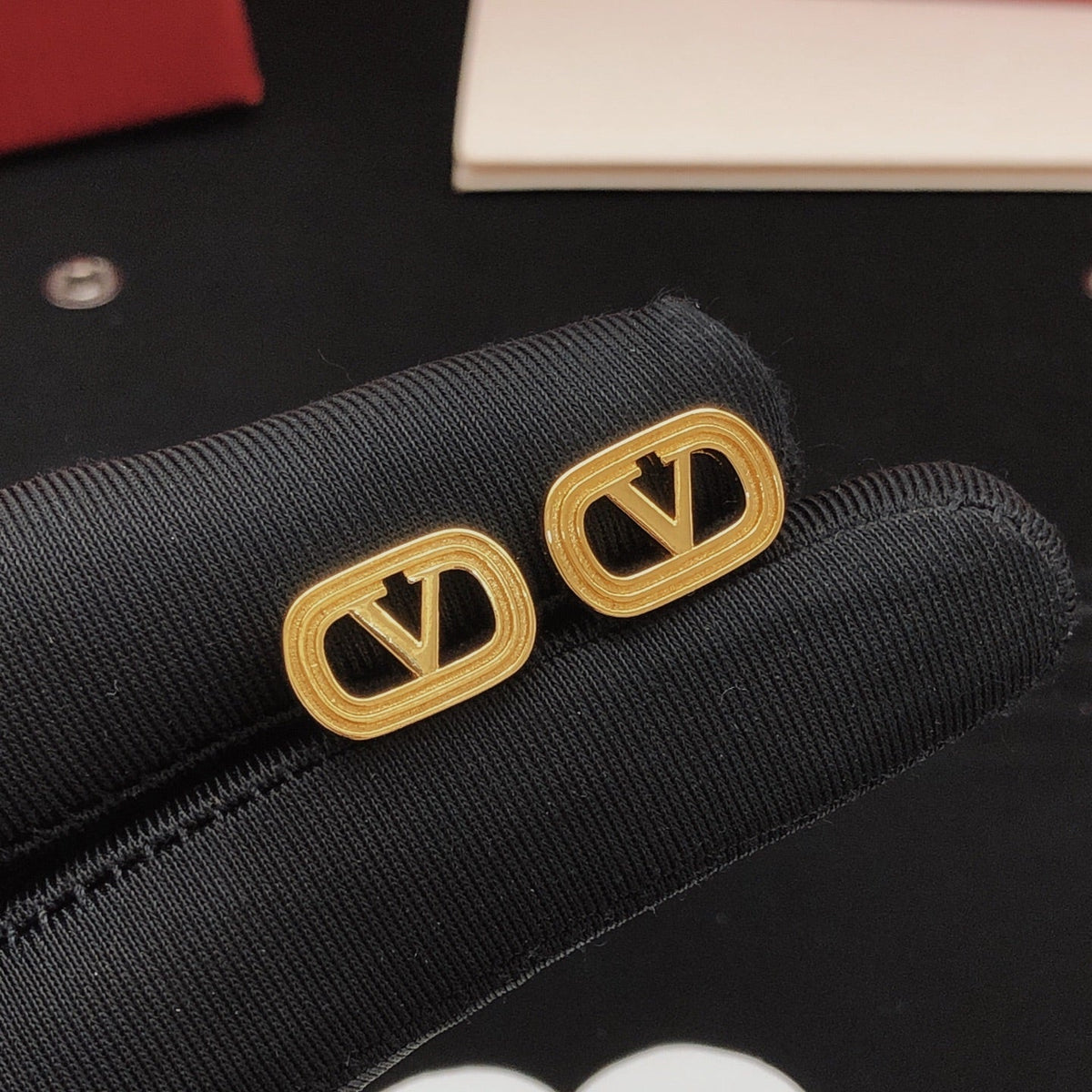 Martin Graham stud earrings in polished metal-tone – side detail