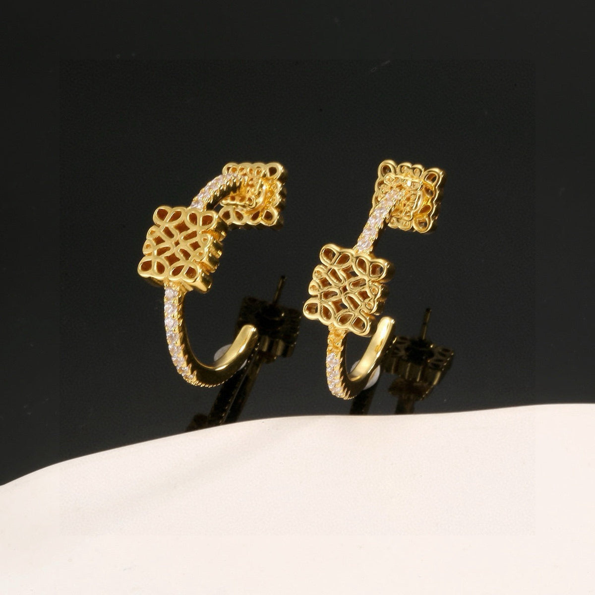 Martin Graham stud earrings in polished metal-tone – side detail