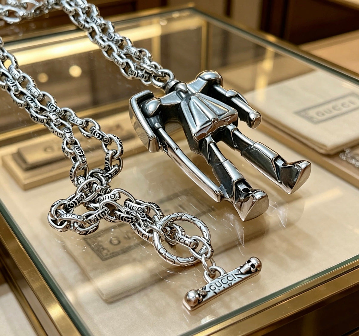 Martin Graham pendant necklace in polished metal-tone – side detail
