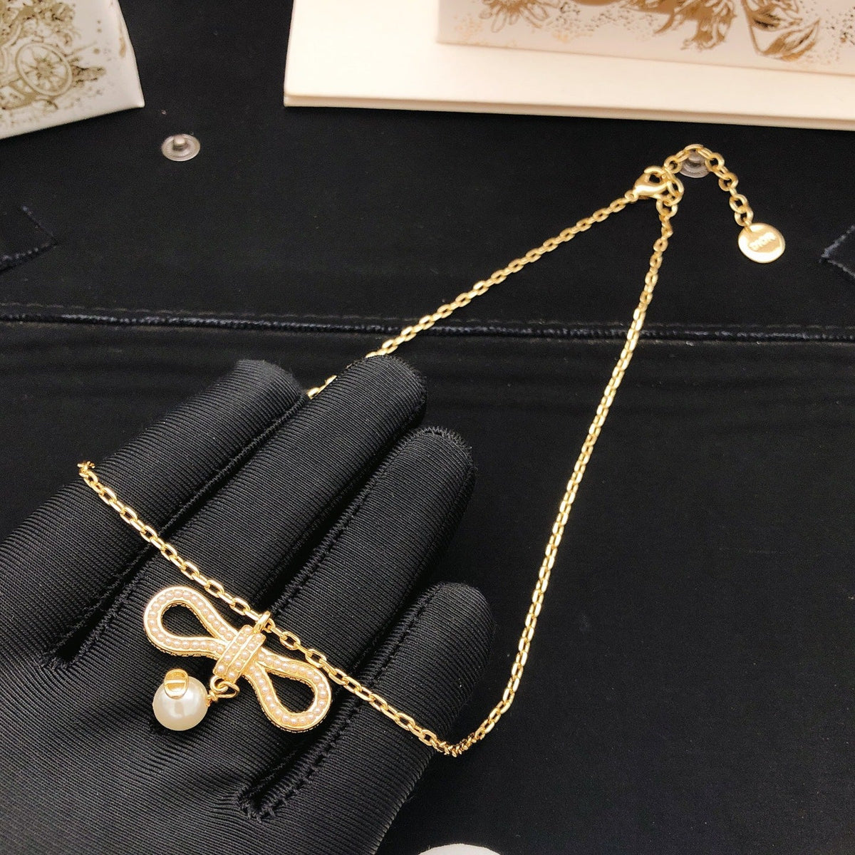Martin Graham pendant necklace in polished metal-tone – side detail