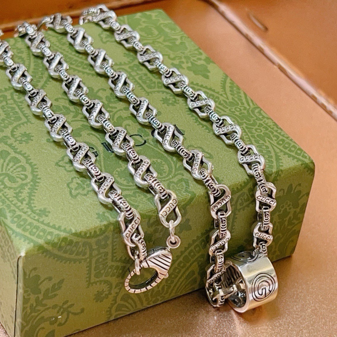 Martin Graham pendant necklace in polished metal-tone – side detail