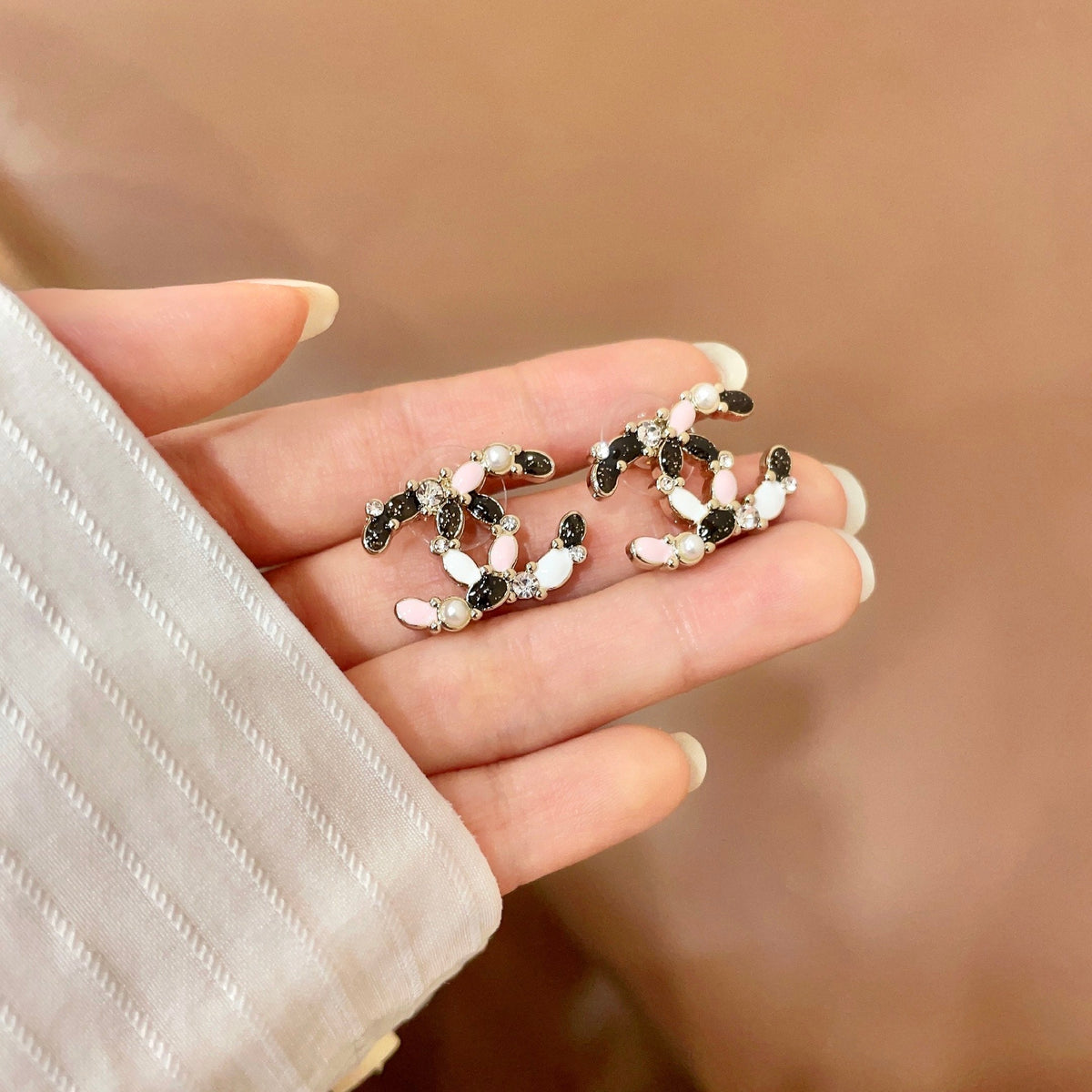 Martin Graham stud earrings in polished metal-tone – side detail
