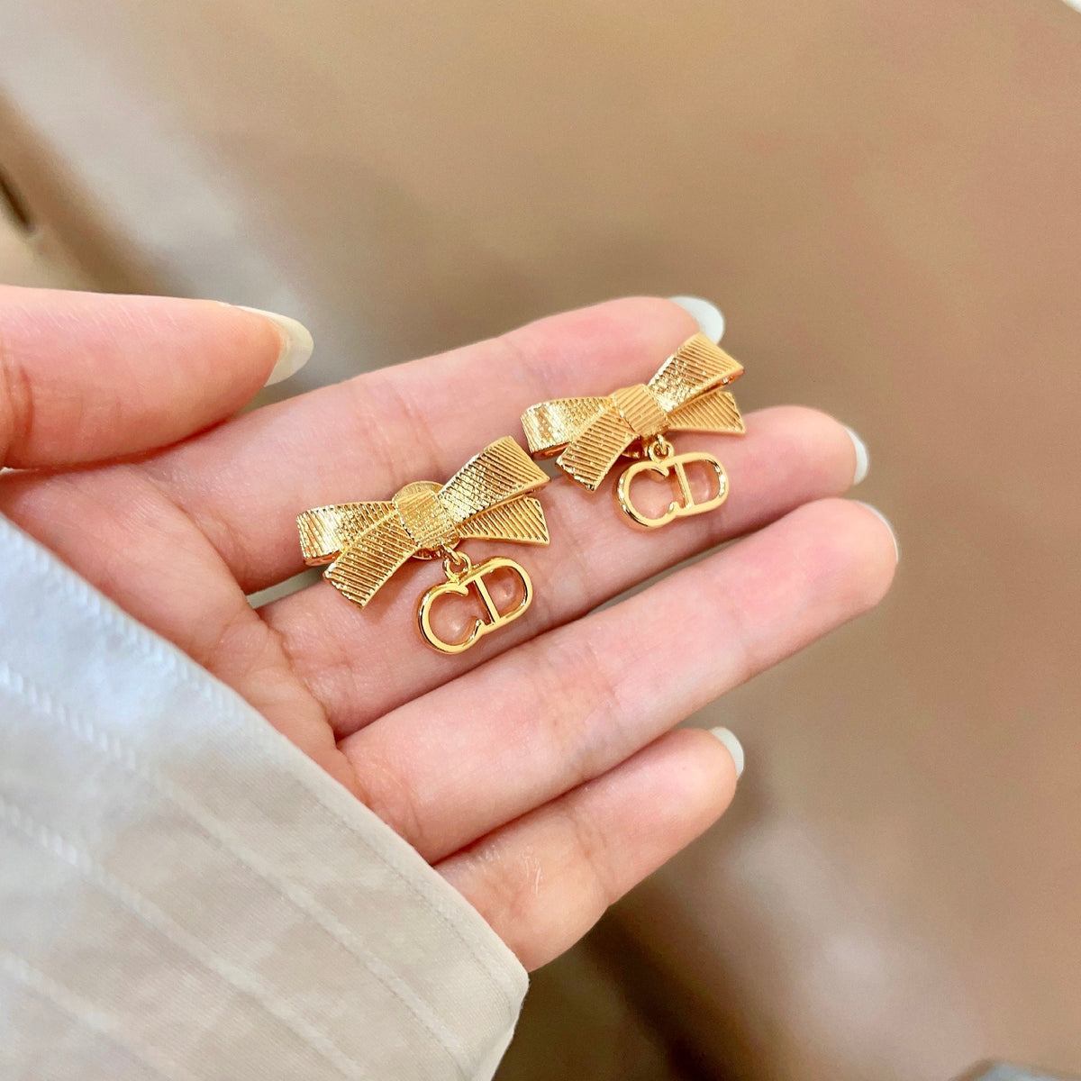 Martin Graham stud earrings in polished metal-tone – side detail