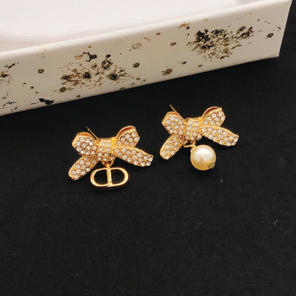 Martin Graham stud earrings in polished metal-tone – side detail