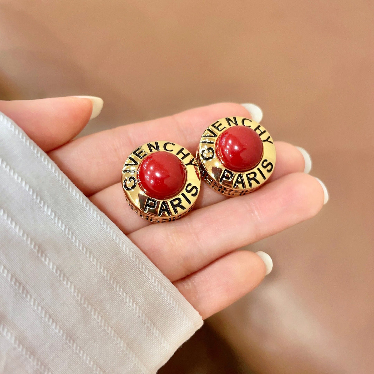Martin Graham stud earrings in polished metal-tone – side detail