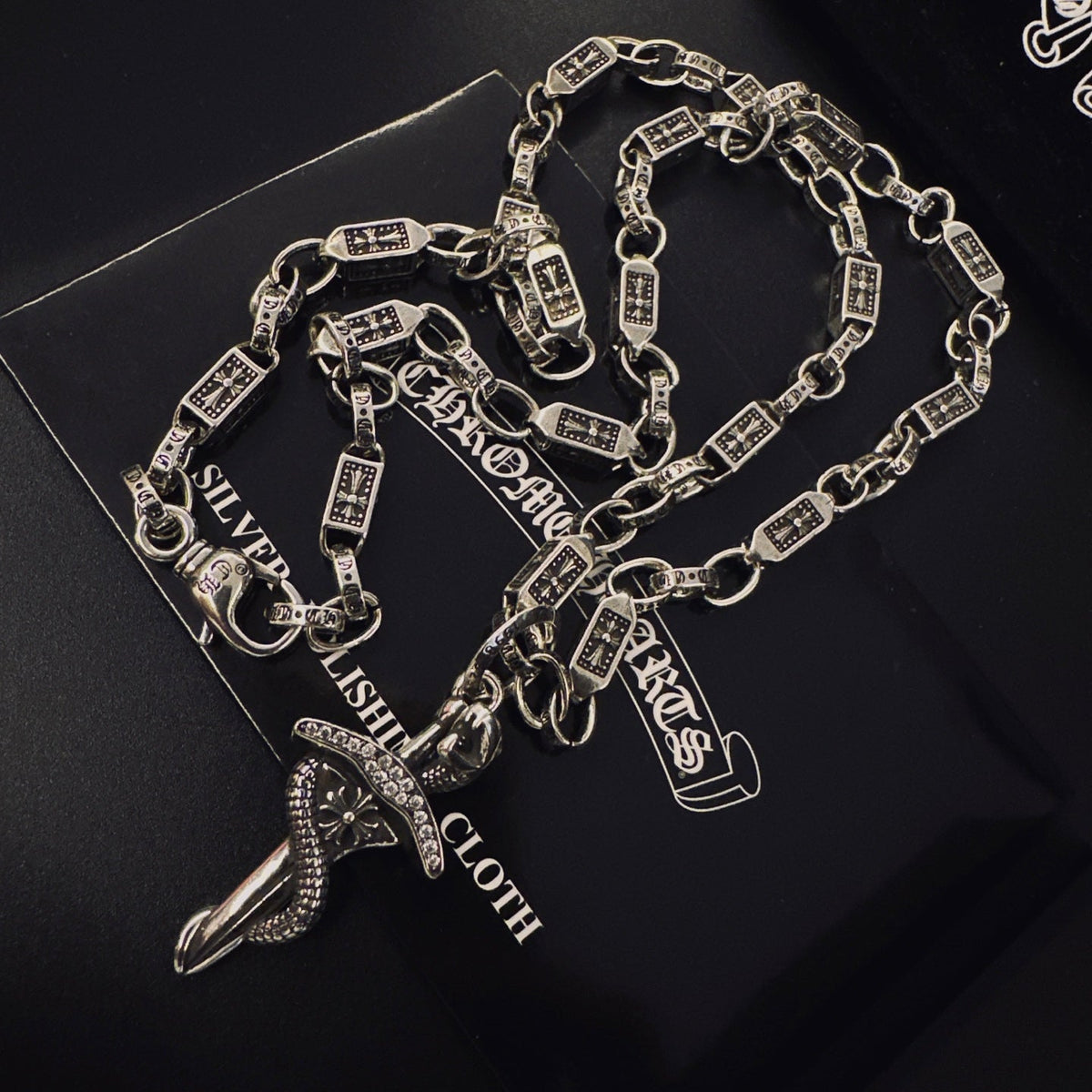 Martin Graham pendant necklace in polished metal-tone – side detail