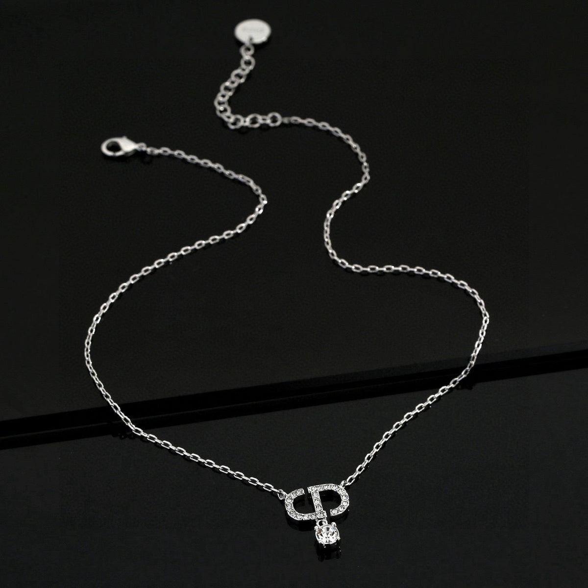 Martin Graham pendant necklace in polished metal-tone – side detail