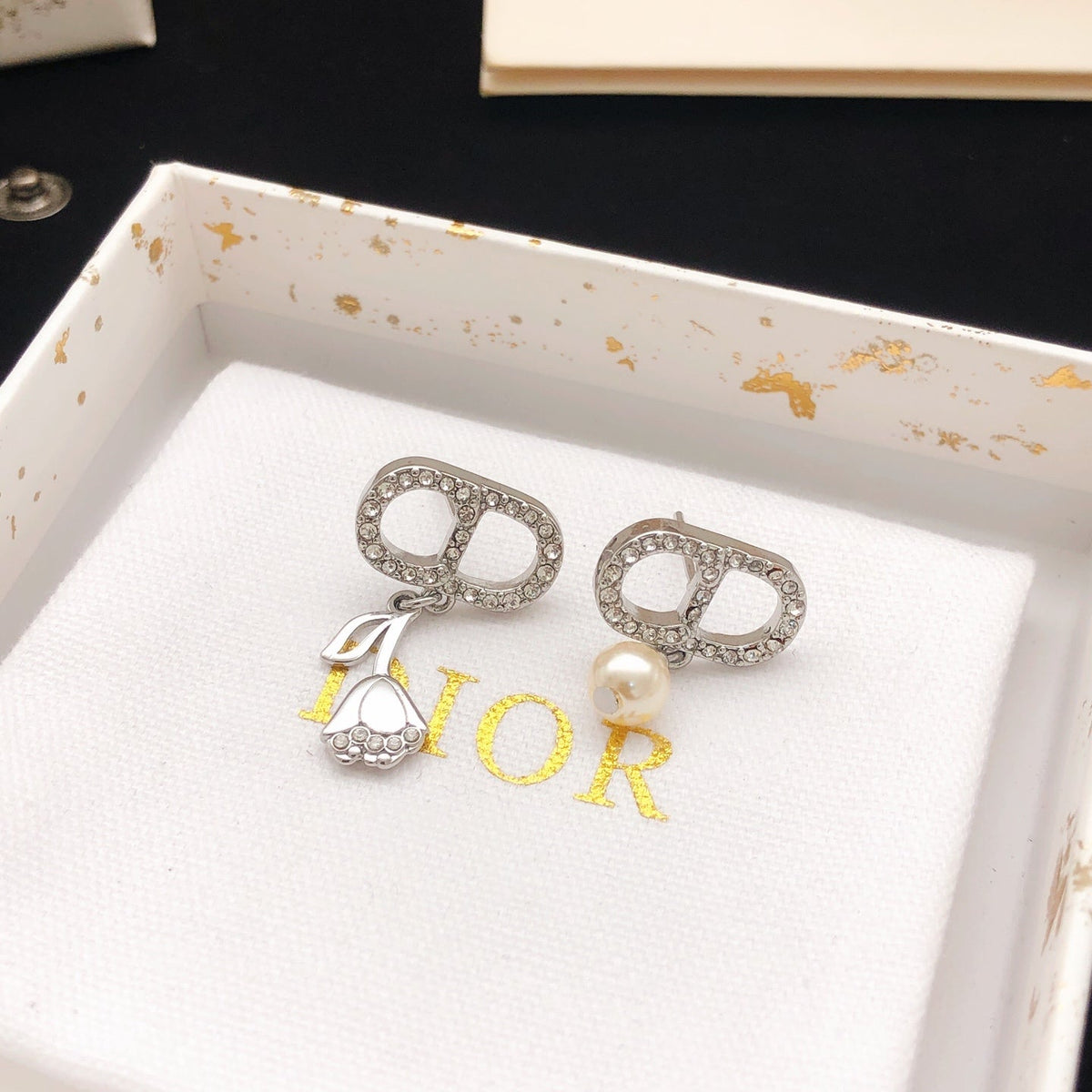 Martin Graham stud earrings in polished metal-tone – side detail