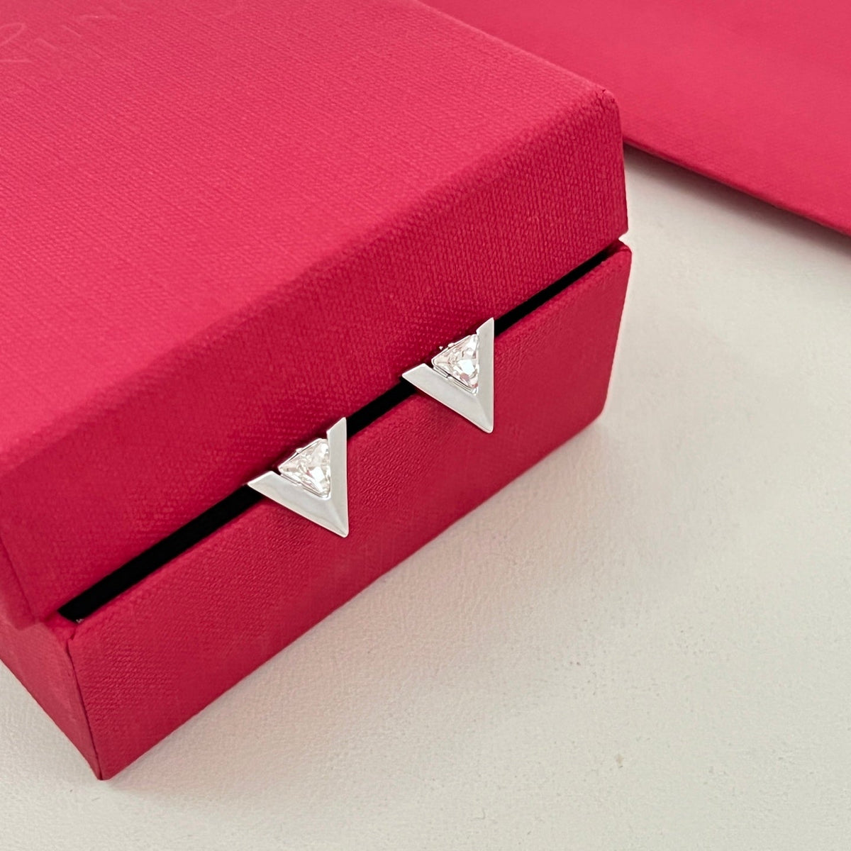 Martin Graham stud earrings in polished metal-tone – side detail