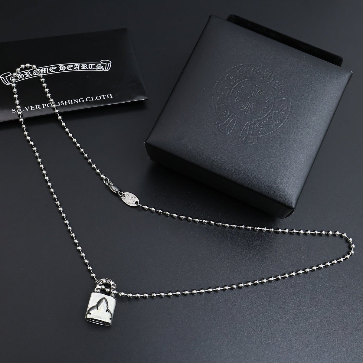 Martin Graham pendant necklace in polished metal-tone – side detail