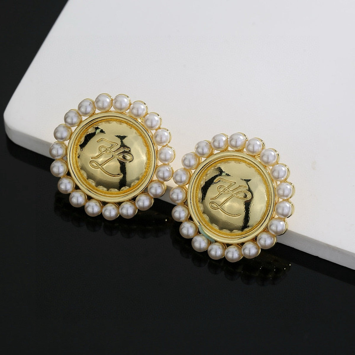Martin Graham stud earrings in polished metal-tone – side detail