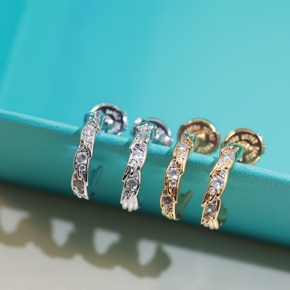Martin Graham stud earrings in polished metal-tone – side detail