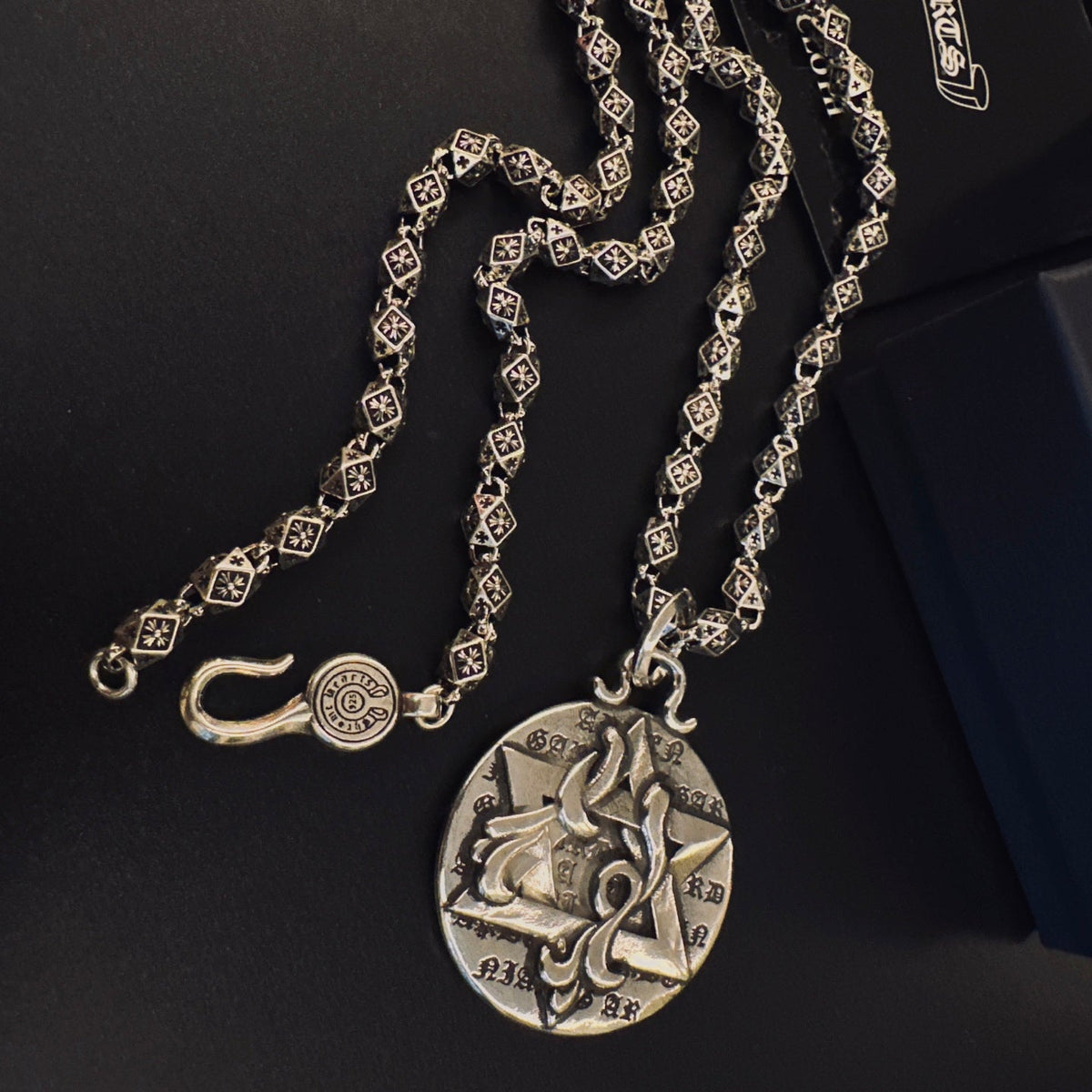 Martin Graham pendant necklace in polished metal-tone – side detail