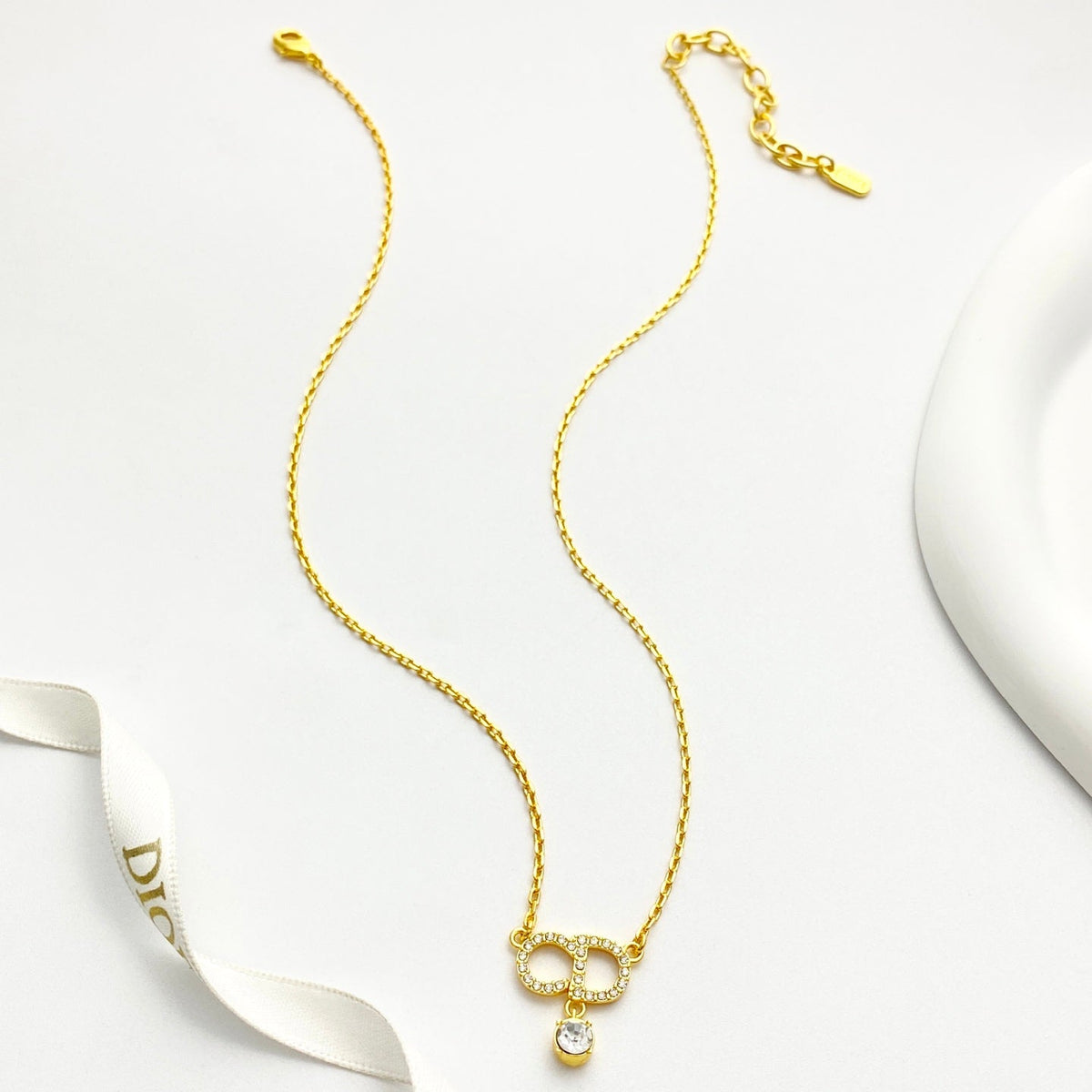 Martin Graham pendant necklace in polished metal-tone – side detail