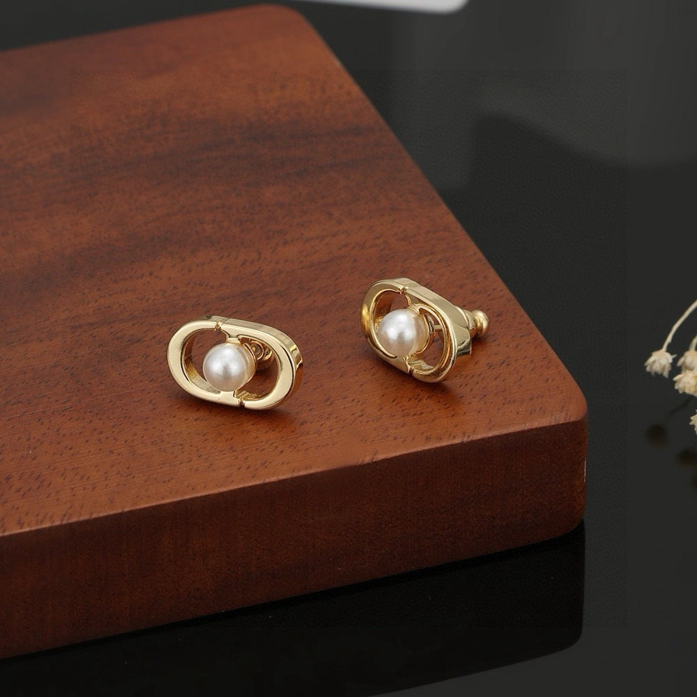 Martin Graham stud earrings in polished metal-tone – side detail