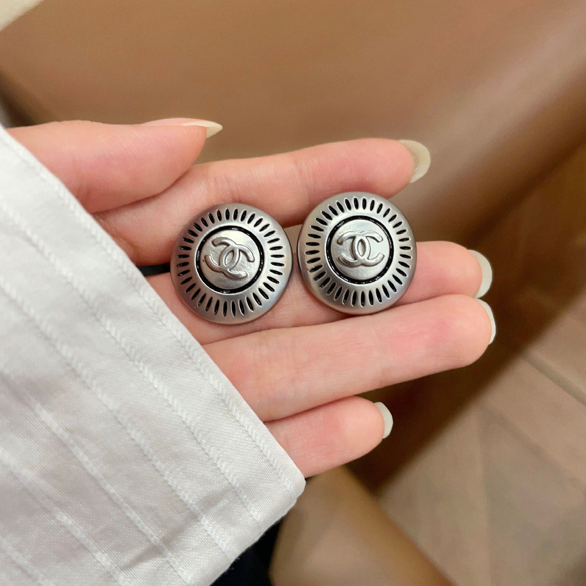 Martin Graham stud earrings in polished metal-tone – side detail