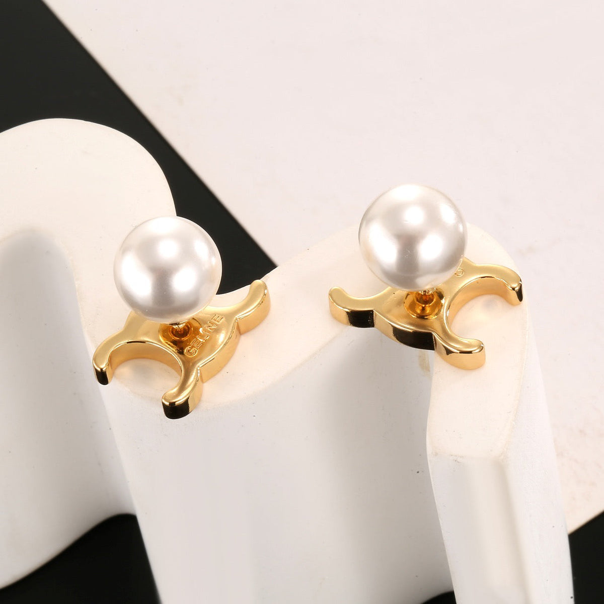Martin Graham stud earrings in polished metal-tone – side detail