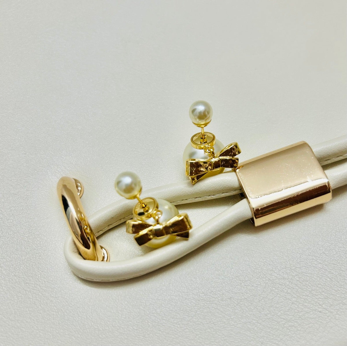 Martin Graham stud earrings in polished metal-tone – side detail