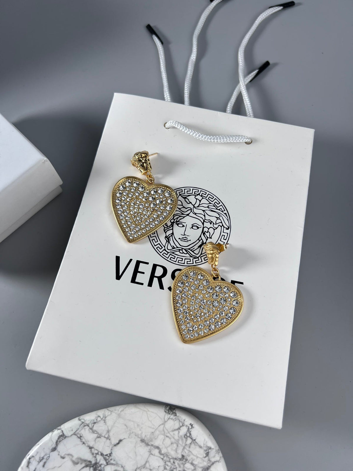 Martin Graham stud earrings in polished metal-tone – side detail
