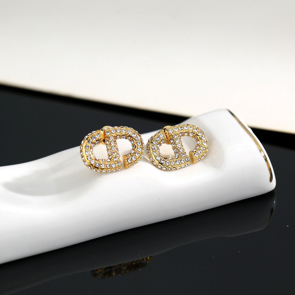 Martin Graham stud earrings in polished metal-tone – side detail