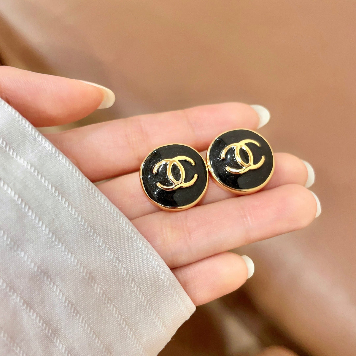 Martin Graham stud earrings in polished metal-tone – side detail