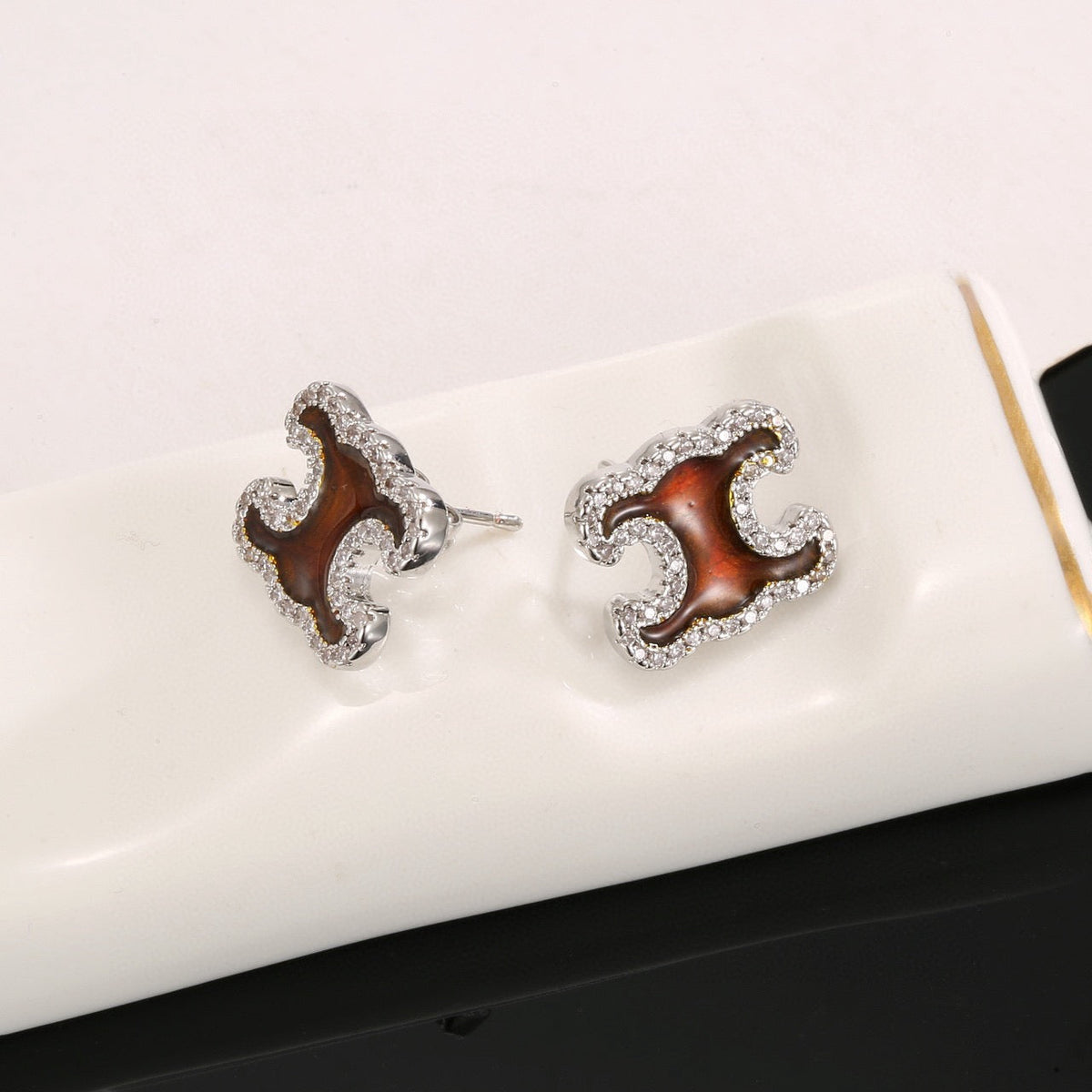 Martin Graham stud earrings in polished metal-tone – side detail