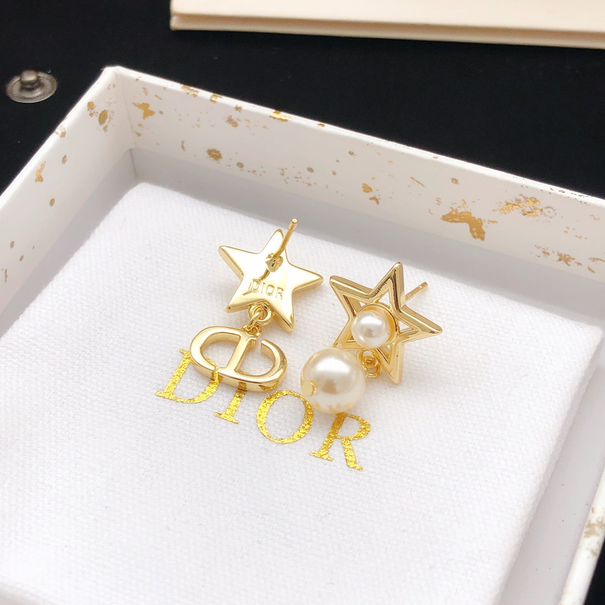 Martin Graham stud earrings in polished metal-tone – side detail
