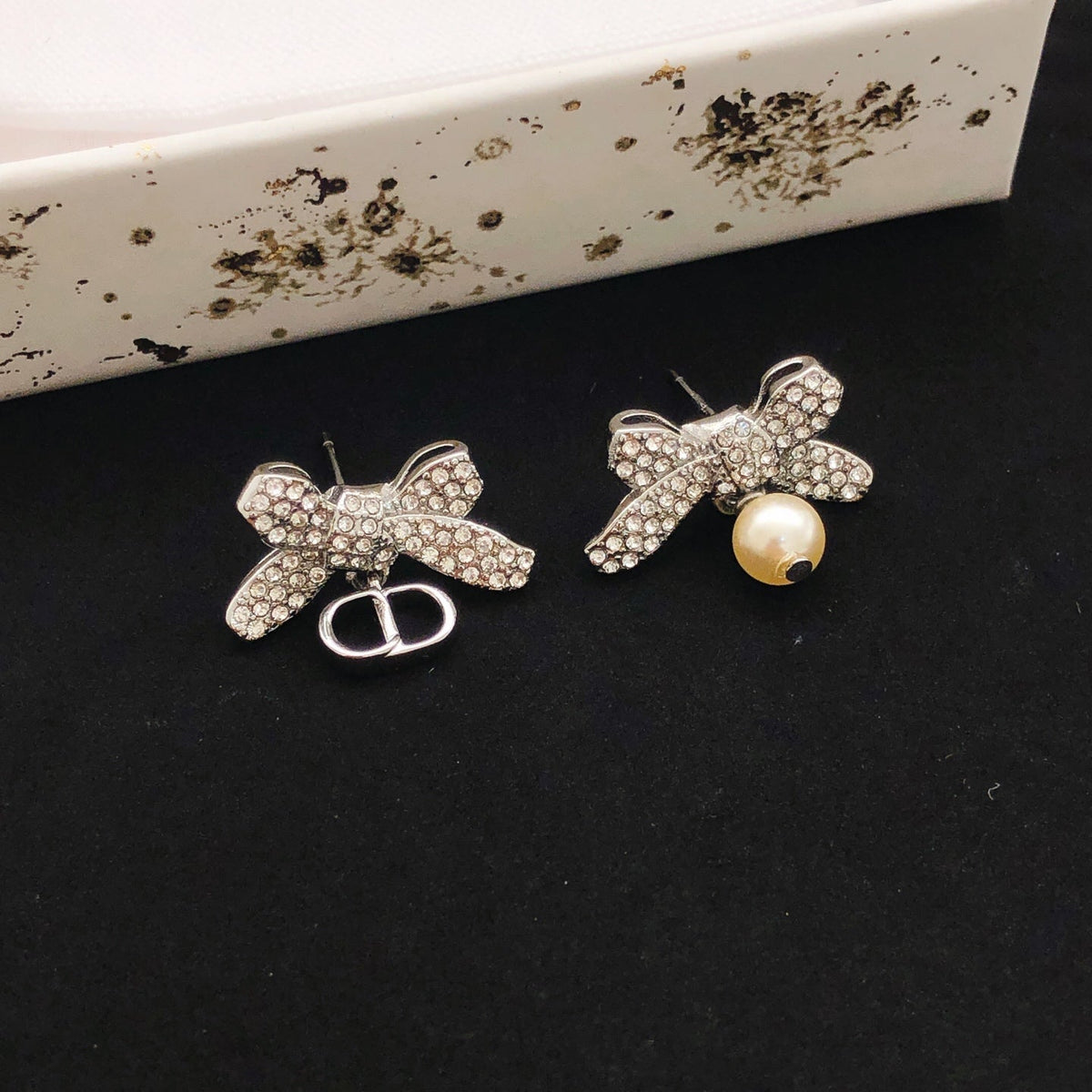 Martin Graham stud earrings in polished metal-tone – side detail