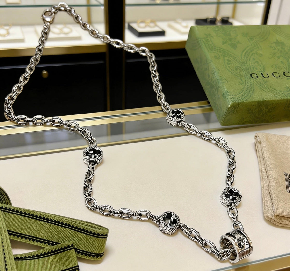 Martin Graham pendant necklace in polished metal-tone – side detail