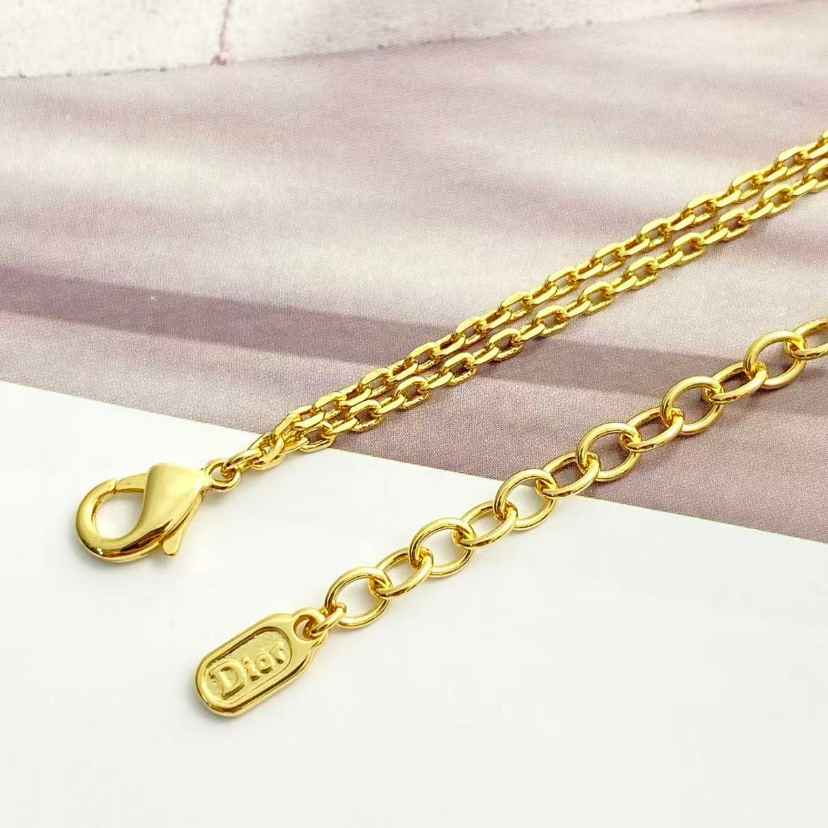 Martin Graham pendant necklace in polished metal-tone – side detail