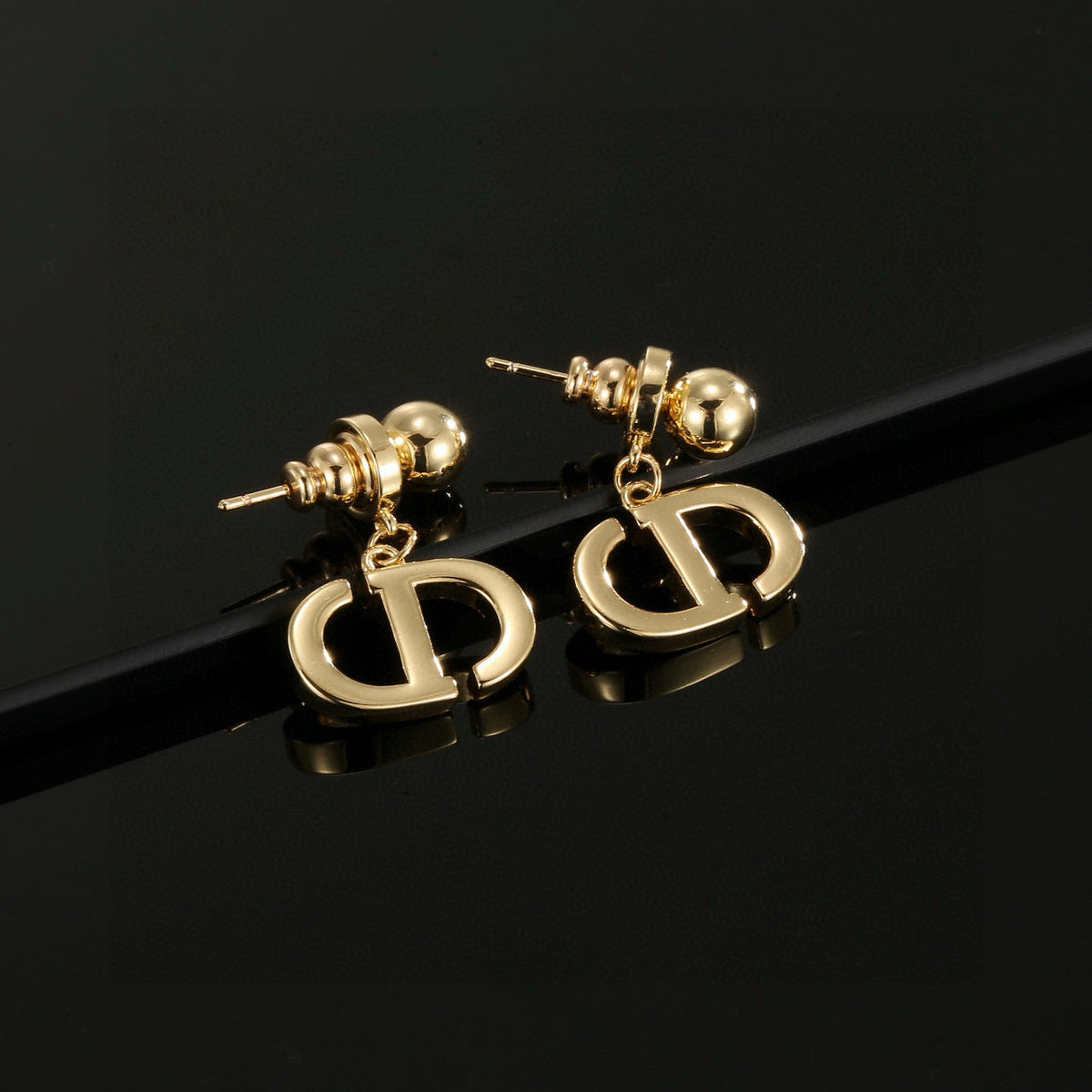 Martin Graham stud earrings in polished metal-tone