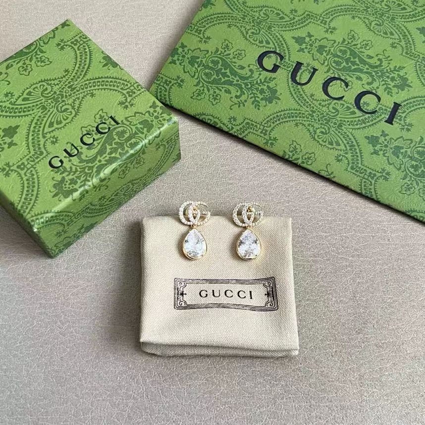 Martin Graham stud earrings in polished metal-tone – close-up detail