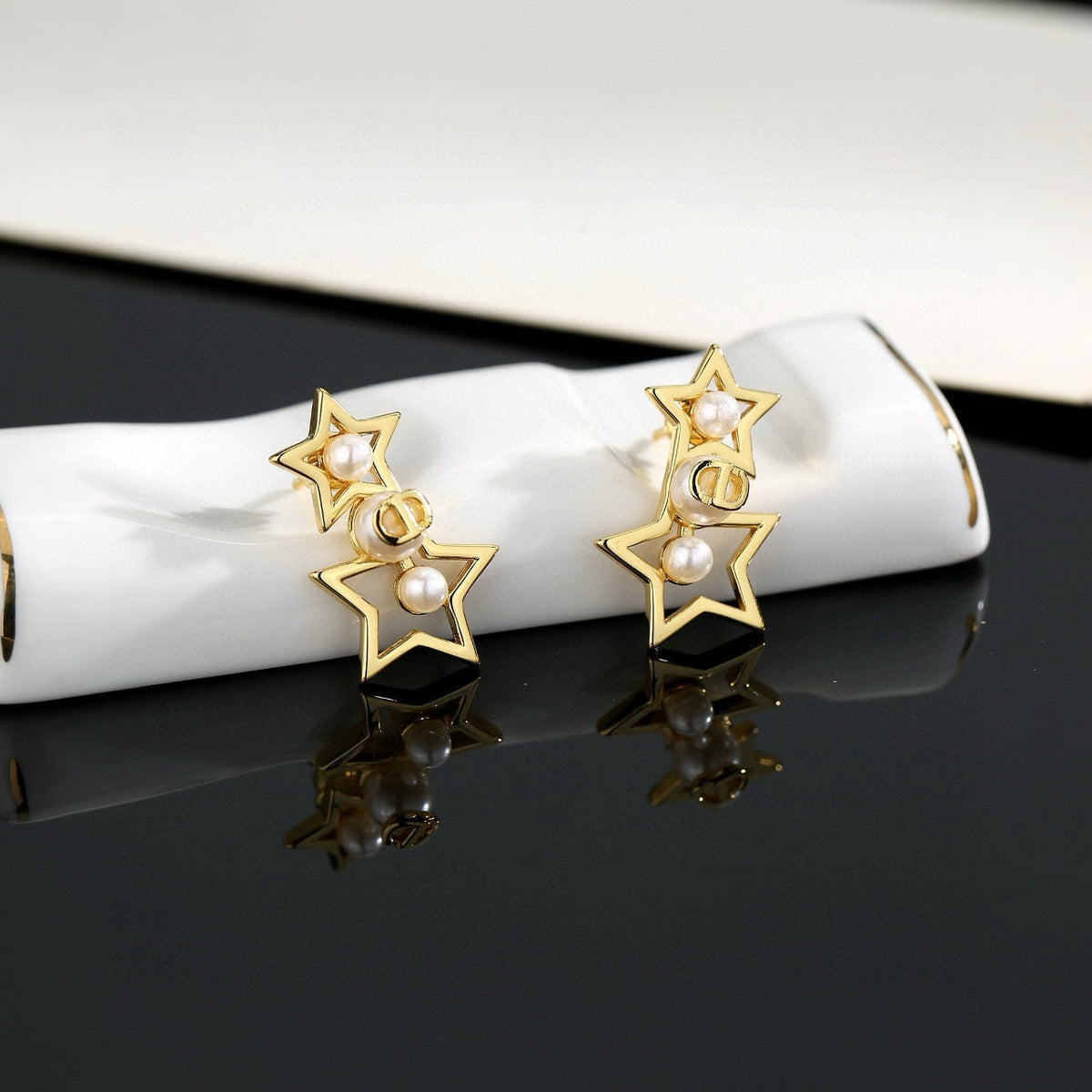 Martin Graham stud earrings in polished metal-tone