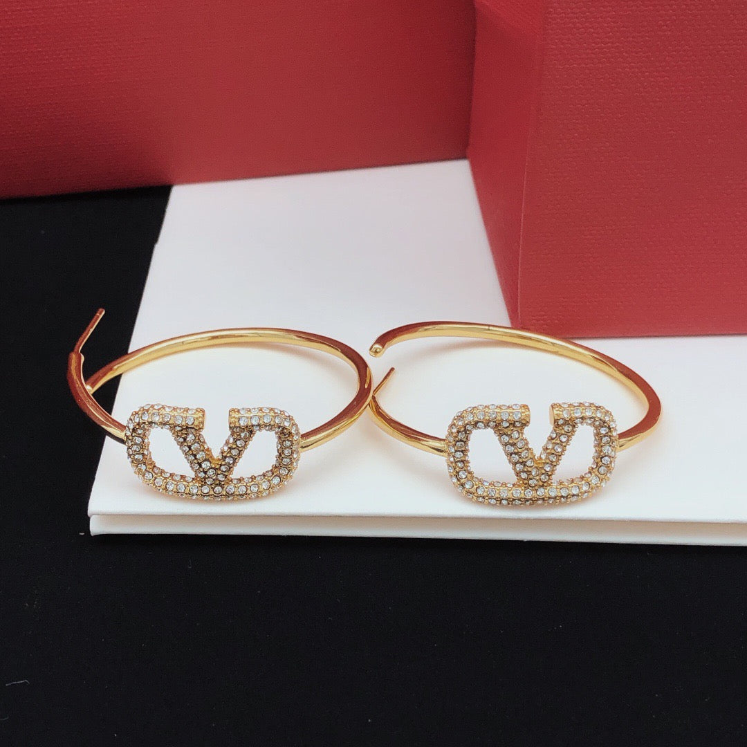 Martin Graham earrings in polished metal-tone