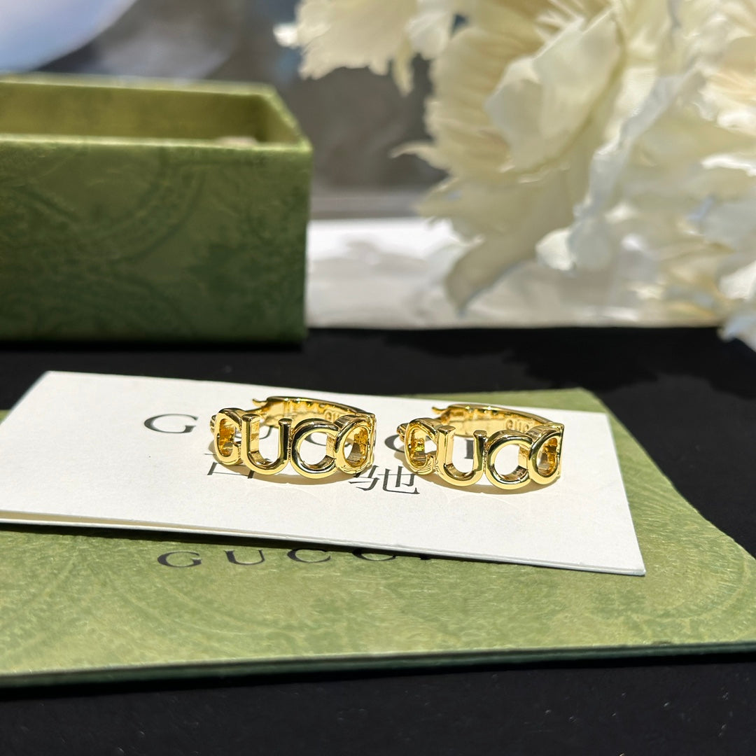 Martin Graham earrings in polished metal-tone – close-up detail
