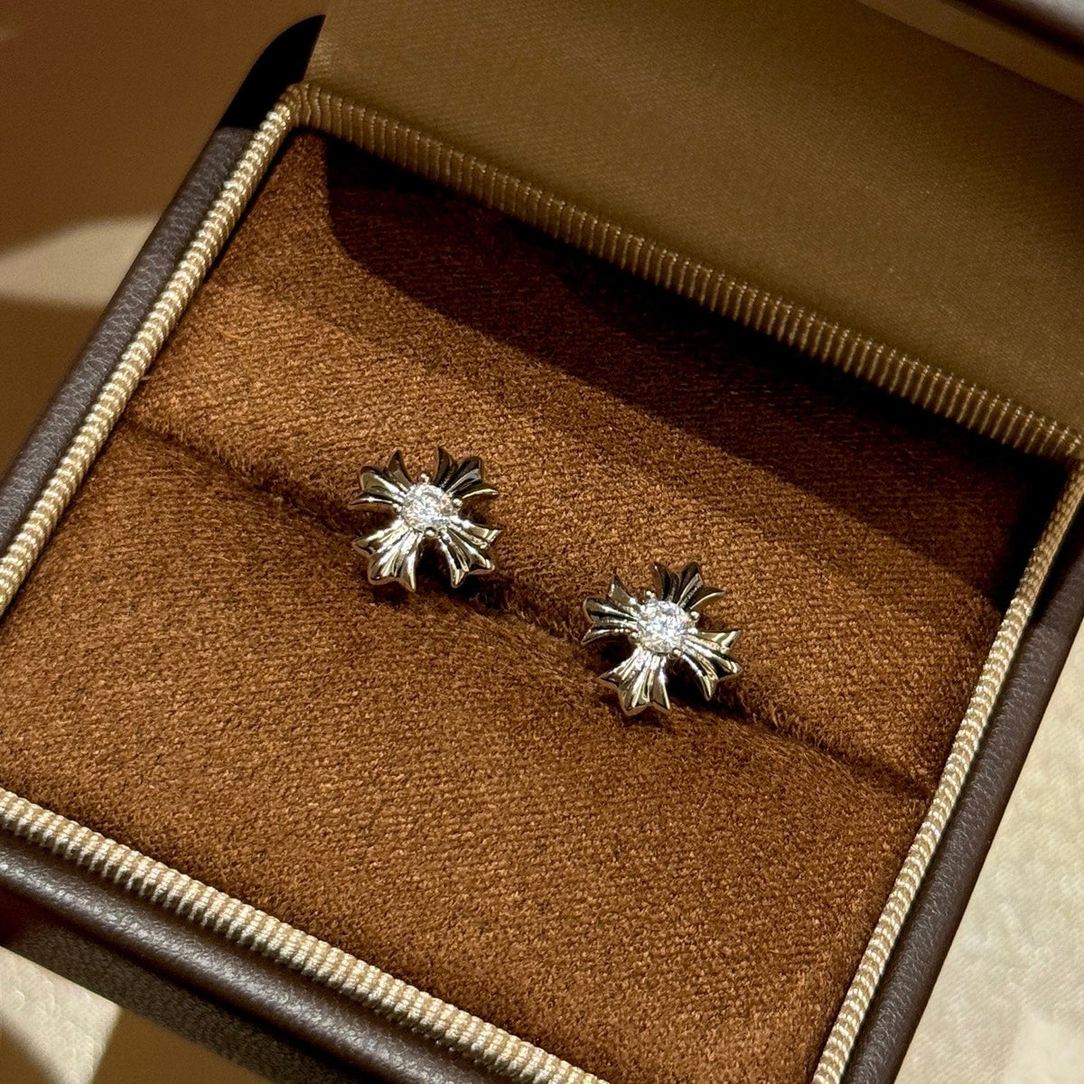 Martin Graham stud earrings in polished metal-tone – close-up detail